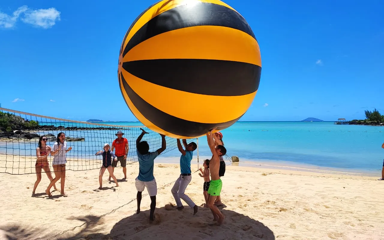 Giant volleyball game on beach lagoon at hotel event in Mauritius