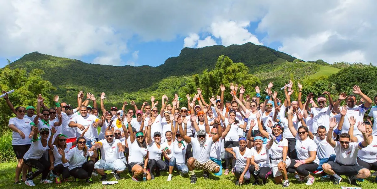 Large group team building event with mountain backdrop in Mauritius