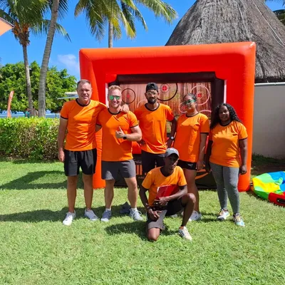 TBM crew in orange team shirts at a resort