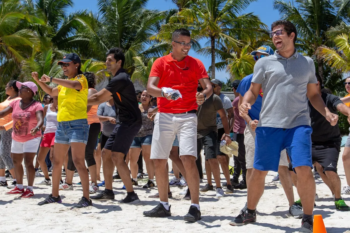Team warmup dance under palm trees